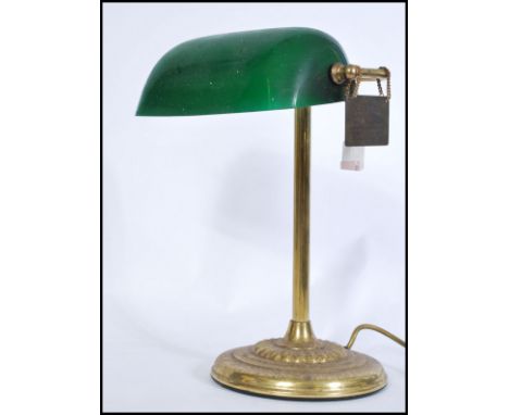 A vintage 20th century gilt brass bankers lamp raised on circular base with adjustable green glass shade. 40cm-high 27cm-wide