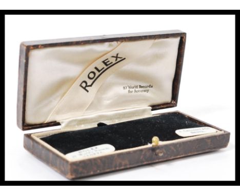 A vintage 20th century Rolex watch box having a leatherette covering with gilt tooled decoration. Opens to reveal silk liner 