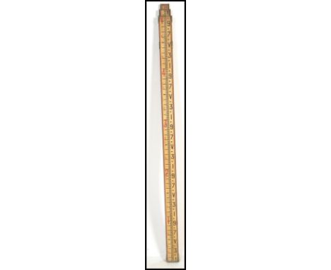 A vintage 20th century industrial metamorphic measuring stick slide rule having a telescoping sliding action.