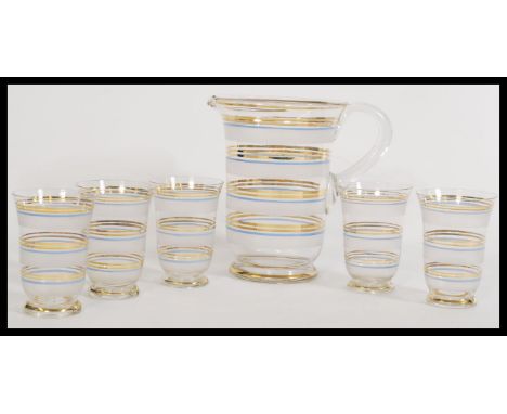 An early 20th Century vintage frosted and clear glass lemonade set to include glasses and pitcher with blue and gilt banded d