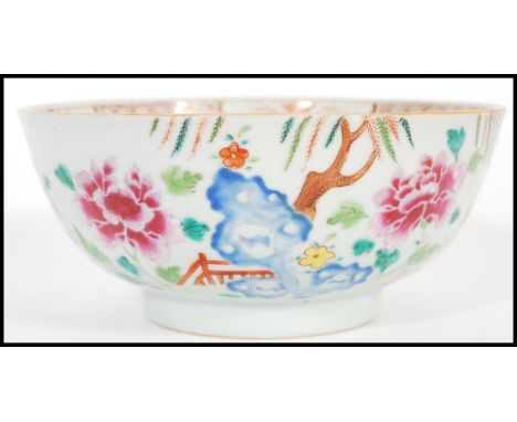 An 18th century small Cantonese Chinese ceramic bowl having hand painted floral spray with trees leaves and bridge. The bowl 