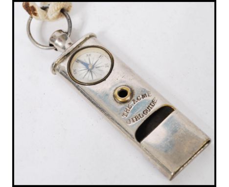 A vintage 20th century ACME girl guide whistle and compass compendium on string necklace. Measures 8cm long.&nbsp;