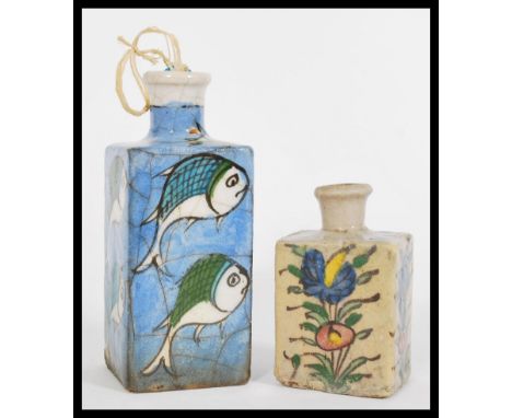 Two early 20th century Qajar style Persian ceramic flask/ bottle vases, the smaller having hand painted florals and the large