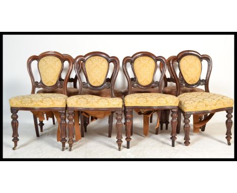 A run of eight 19th Century mid Victorian mahogany trefoil / balloon back dining chairs jhaving overstuffed seats raised on&n