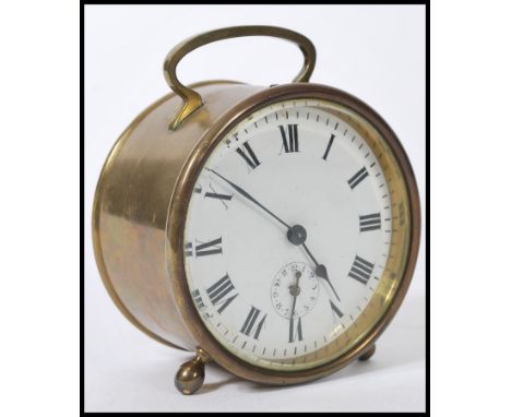 A 19th century Victorian brass alarm clock of round form with a white enamelled round face and roman numerals to the chapter 