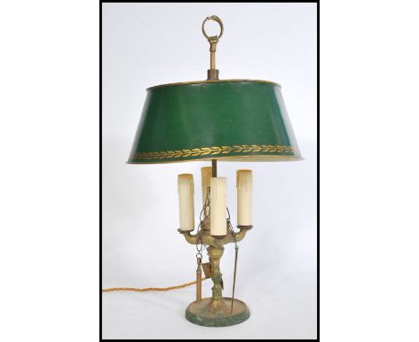 A Louis XVI Bouillotte four light candleabra coaching lamp on a round base with a green tole shade having gilt foliate decora