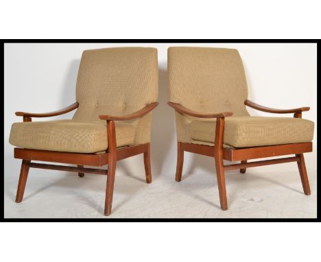 A pair of Danish style retro 20th Century open framed teak wood lounge /&nbsp;fireside armchairs each being upholstered with 
