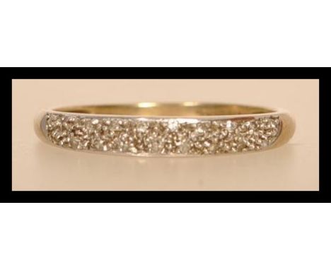 A hallmarked 9ct gold and diamond half eternity ring having half decoration with illusion set diamonds. Wight 1.7g. Size T.