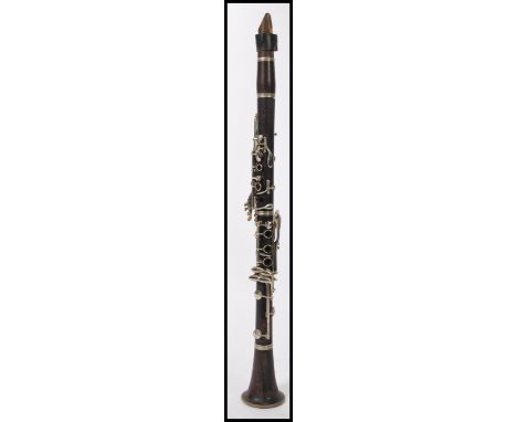 A vintage early 20th Century Buffet Compton &amp; Co rosewood clarinet, with nickel plated keys and mounts, stamped Buffet Co