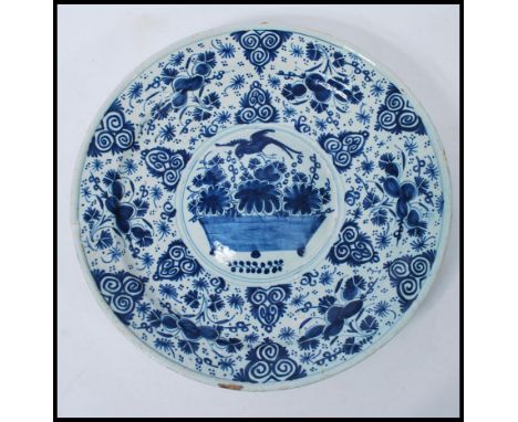 A 19th Century Delft display / serving plate of round form, having hand painted blue and white floral decoration having a cir