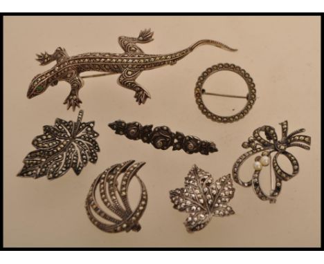 A selection of vintage 20th century silver white metal and marcasite brooches to include a brooch in the form of a lizard, tw