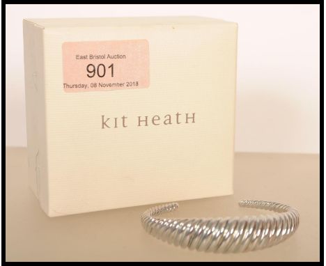 A silver bangle by Kit Heath of twisted form, stamped 925. Weight 39g.&nbsp;