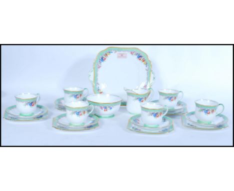 A vintage Aynsley English Fine Bone China six person tea service having floral decoration. Reg No 778491.&nbsp;Measures 26cm-