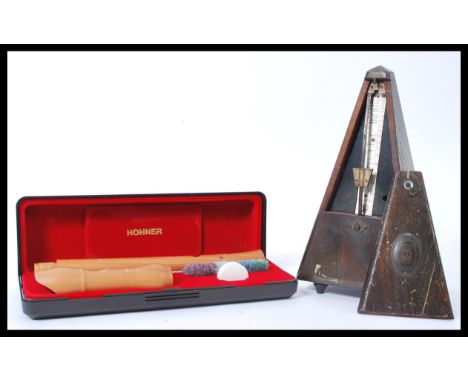 A vintage early 20th Century German ' System Maelzel ' metronome together with a Hohner Baroque cased recorder. Measures 23cm
