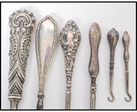 A selection of 20th century silver handled steel button hooks also including a late 19th century button hook with a decorativ