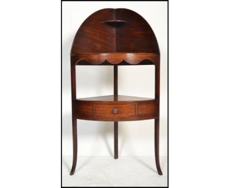 A George III solid mahogany corner washstand - whatnot etargere. Raised on shaped legs with single drawer tier beneath shelf 