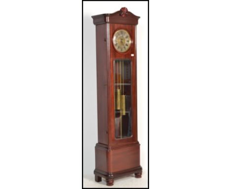 A 1920's large mahogany cased Westminster chiming longcase / grandfather clock. The dome top case with large silvered dial ha