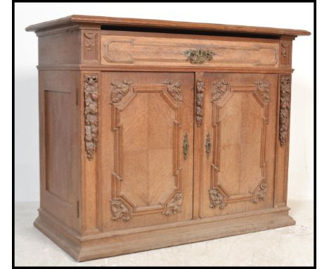 A 19th century oak french buffet de corps, sideboard with a fruit wood top and carved detailing to the front, with two short 