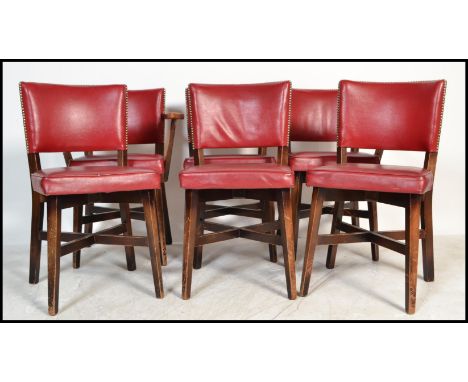 A set of six vintage 20th Century dining chairs ( two carvers ) in the manner of Ben Chairs, the chairs upholstered in a red 