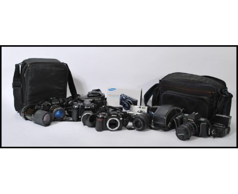A collection of digital and vintage 35 mm cameras and lenses, to include a Nikon D40 and lens, Fujifilm Finepix and lens, cas