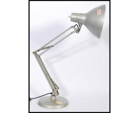 A vintage retro 20th century industrial anglepoise lamp raised on a circular base with pendant.