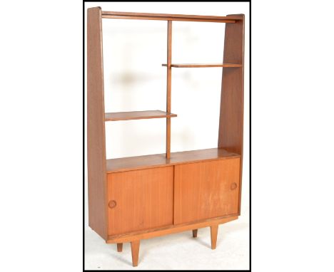 A vintage / retro 20th Century teak wood room divider bookcase / upright cabinet. Raised on shaped legs, sliding cupboard to 