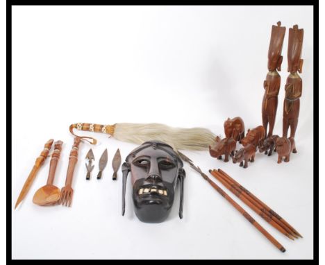 A collection of vintage 20th Century African tribal items to include a hard wood wall hanging face mask with bone teeth, spea