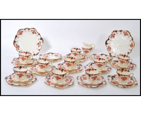 A 19th Century Victorian tea service by Paragon, in a blue and red Imari pattern having gilt rims and scrolled handles to inc