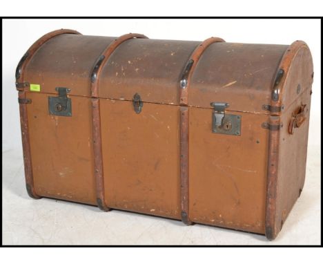 A vintage early 20th Century dome top canvas and cane bound steamer trunk, brass locks fitted to the hinged top. Measures 60 