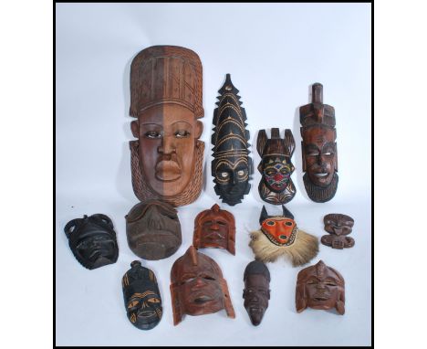 A collection of vintage wooden African tribal masks - wall hanging. To include hardwood and ebony examples with hand painted 