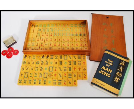 A vintage 20th century Mahjong gaming set, having 152 yellow plastic / Lucite pieces bearing character marks in a fitted wood