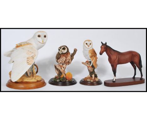 A group of ceramic and resin animals to include a Royal Doulton ceramic horse on wooden base, a Franklin mint ceramic snowy o