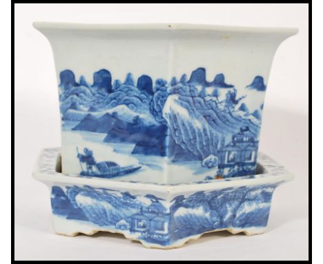An 19th century blue and white ceramic Chinese jardiniere and stand having a hexagonal shape. Hand painting panels depicting 