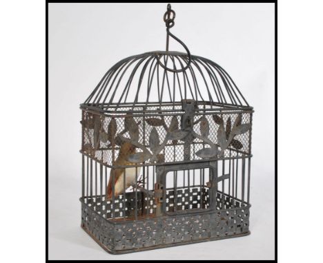 A charming vintage 20th century wire work bird cage having a domed top with hook atop. Complete with model bird. 34cm-high 33
