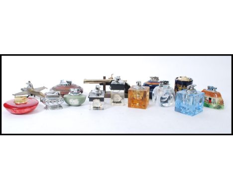 A group of fourteen vintage cigarette lighters to include Ronson, acrylic cubes with inset oysters, cameo, fighter jet, potte