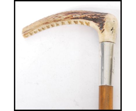 A 19th Century wooden horn handled riding whip having a silver hallmarked collar and leather lash. Hallmarked London 1896. 73