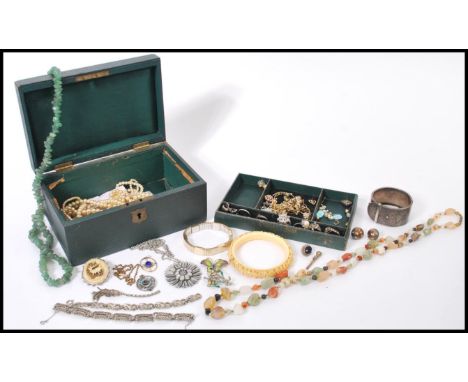 A selection of vintage costume jewellery to include two art deco style marcasite bracelets, two enamelled brooches, a selecti