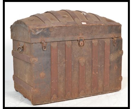A late 19th Century dome topped metal mounted trunk chest, paper lined to the interior, with lock to the front and decorative