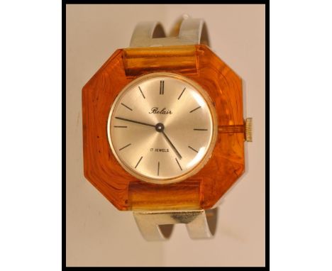 A vintage retro 1970's Belair ladies watch with a round face and stick batons to the chapter ring, in a brown / amber hexagon