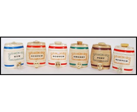 A selection of Wade collectable ceramic barrel decanters to include Scotch, Gin, Port and Sherry. Stamped WADE to the bases. 