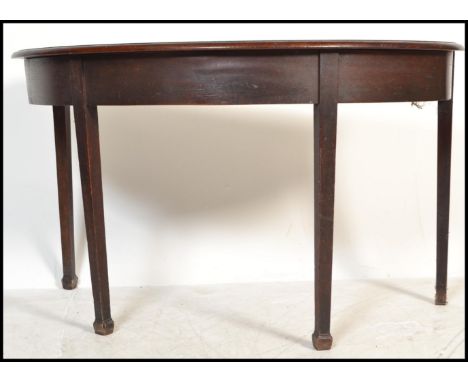 A 19th century mahogany large D-end / demi lune console hall table being raised on square tapered legs with fitted frieze and