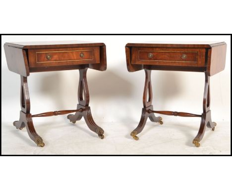 A good pair of Regency revival mahogany drop leaf side / lamp tables, each with single drawers being raised on lyre shaped su
