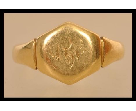 An early 20th century hallmark 18ct gold gentlemans signet ring. The ring has notation on the inside of the shank ' from M. M