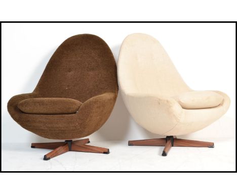 A pair of retro 20th Century swivel&nbsp; egg chairs in the manner of Greaves and Thomas, one chair retaining the original bu