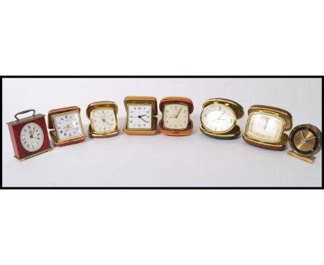 A group of eight vintage 20th century travel alarm clocks most in metamorphic cases. Includes Cyma, Westclox, Europa etc.