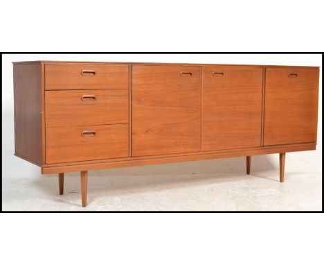 A vintage / retro 20th Century teak wood sideboard / Credenza, having an arrangement of&nbsp; three drawers and cupboards rai