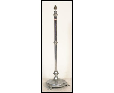 A 1930's Art Deco chrome standard lamp being raised on a stepped circular terraced base with tall column having mount atop.&n
