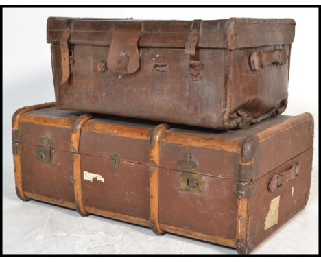 A vintage early 20th Century canvas and cane steamer trunk, together with a stunning early 20th Century leather steamer trunk