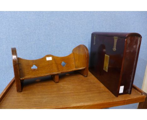 An Arts and Crafts oak book trough and a hardwood and brass mounted book shaped folio box 