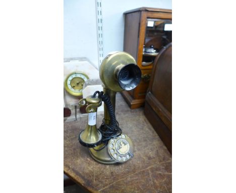 A brass candlestick telephone 